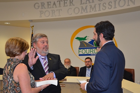 PHOTO: Mr. Randy Adams, bible held by wife Melinda Bruce Adams, is sworn in as interim Port Commissioner for Seat I by Legal Counsel Bryce Autin while Board President Perry Gisclair (L) and Executive Director Chett Chiasson (R) look on.